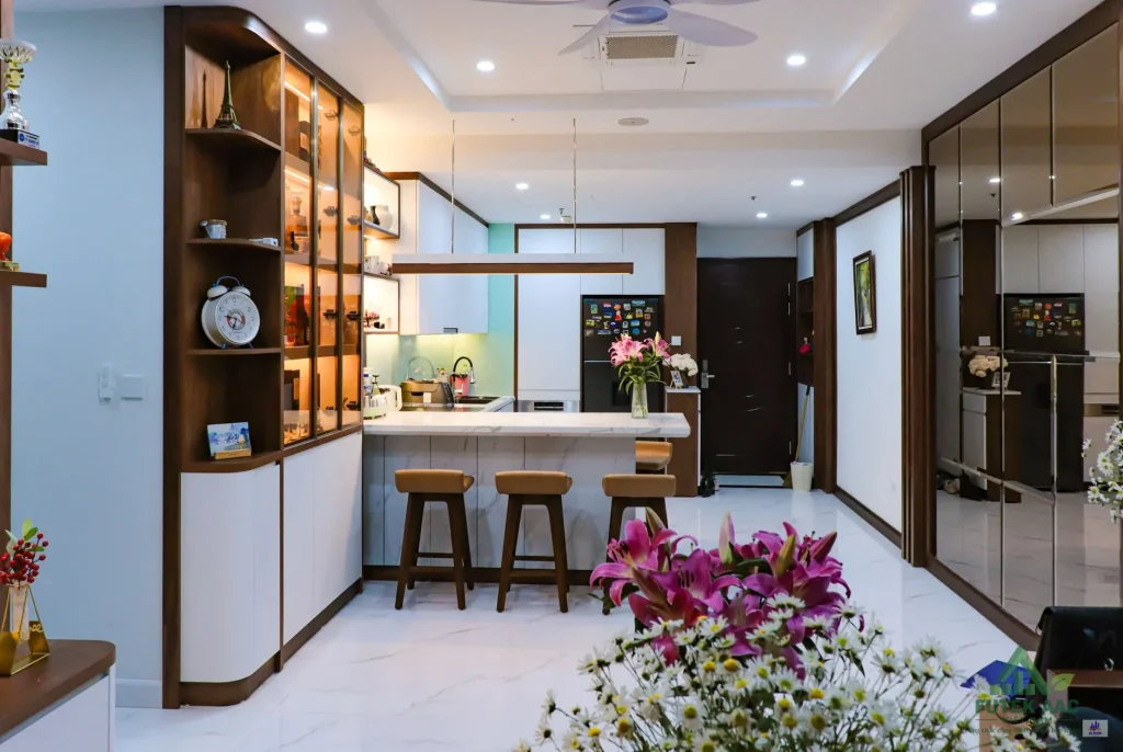 Stylish kitchen featuring a marble island, elegant lighting, and chic decor. Perfect for contemporary home settings.